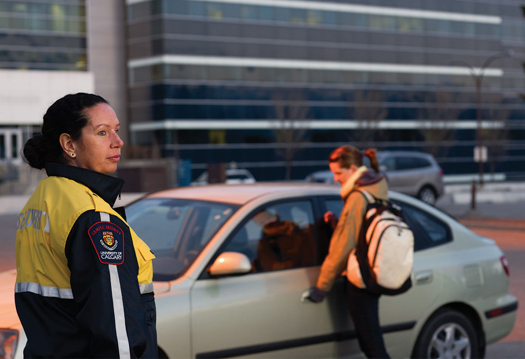 A University of Calgary Campus security staff member patrols a parking lot.