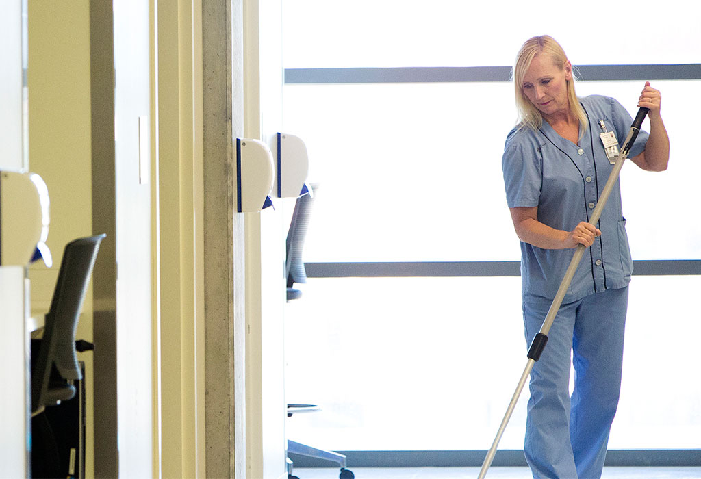 A Local 056 General Support Services (GSS) employee mops the floor.