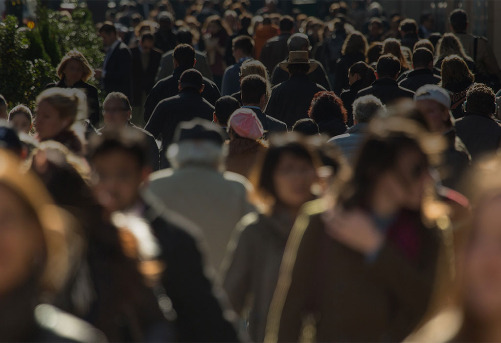 A blurred picture of a crowd of people walking.