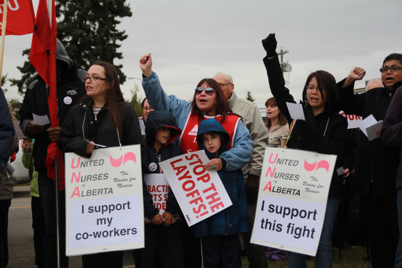 AUPE members and supporters chant and wave signs